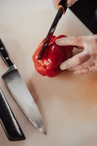 close up of a chef cutting a pepper to see sharpening of high quality chef knives